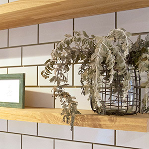 キッチンの背面にあるタイル壁と木製の棚